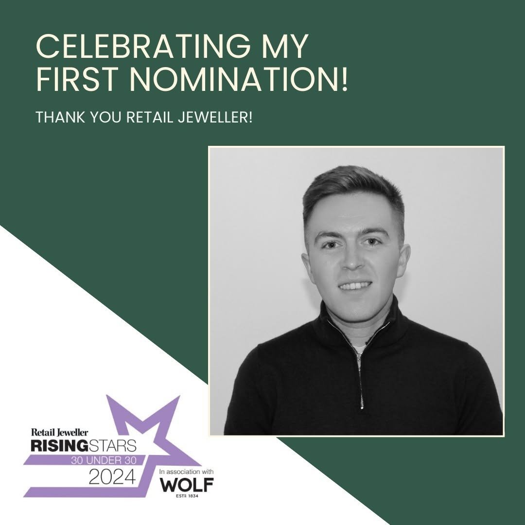 Black and white photo of a young man with short hair wearing a zip-up sweater, smiling slightly, against a plain background. The image is part of a graphic celebrating a first nomination in the retail jewelry industry.