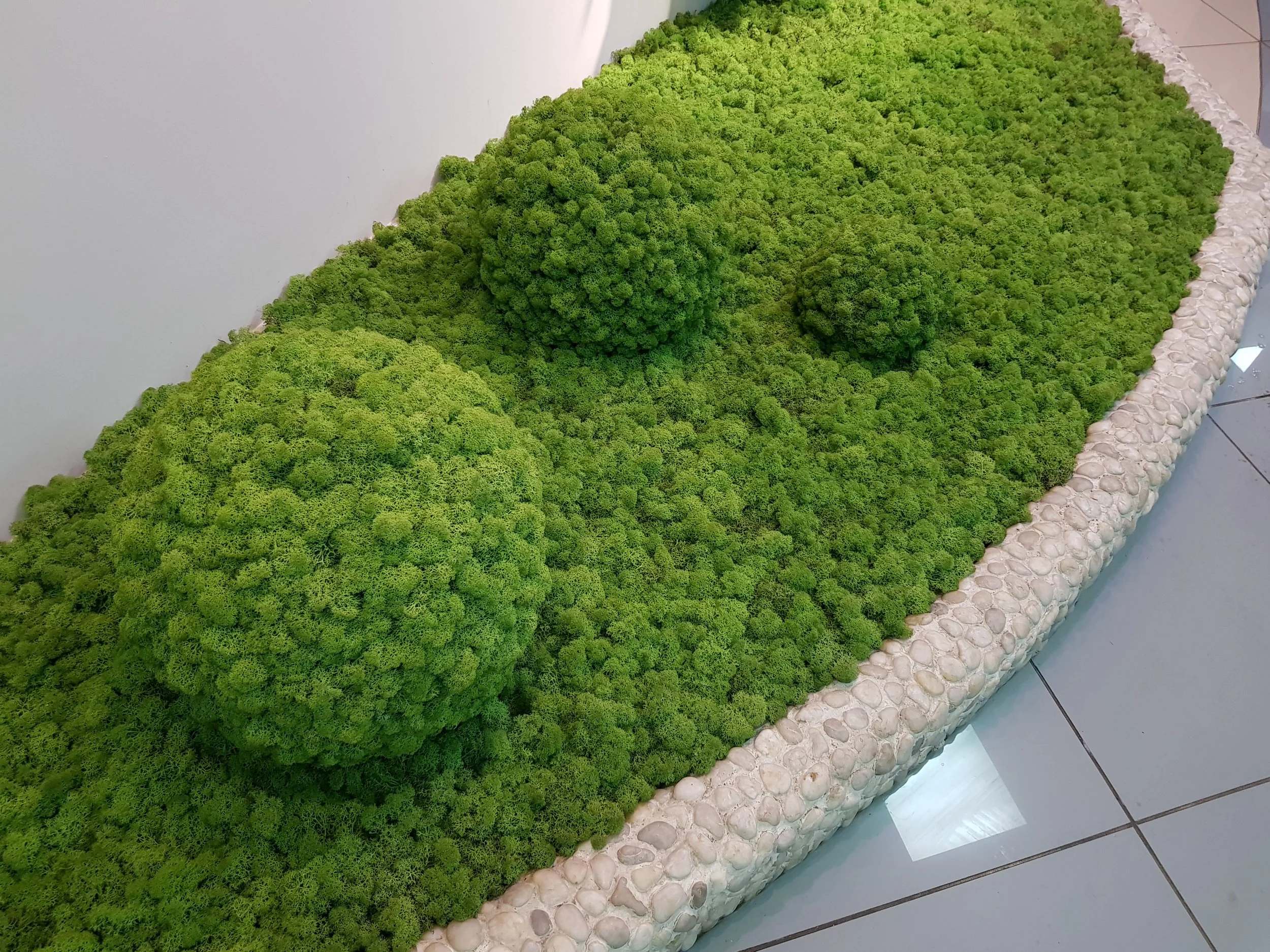 Close-up of a person weaving a patterned textile on a loom, using a shuttle with yarn.
