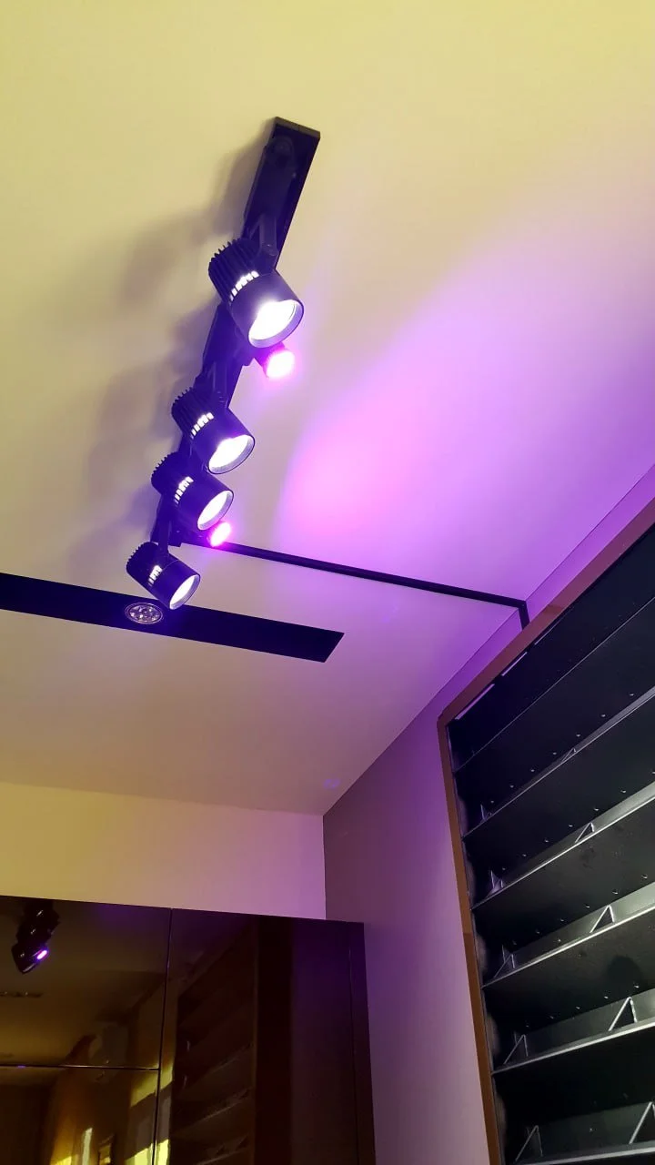 Black, white, and gray patterned rug on wooden porch floor.