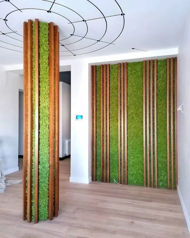 A black and white patterned rug on a wooden porch, with a view of grass and stepping stones outside.