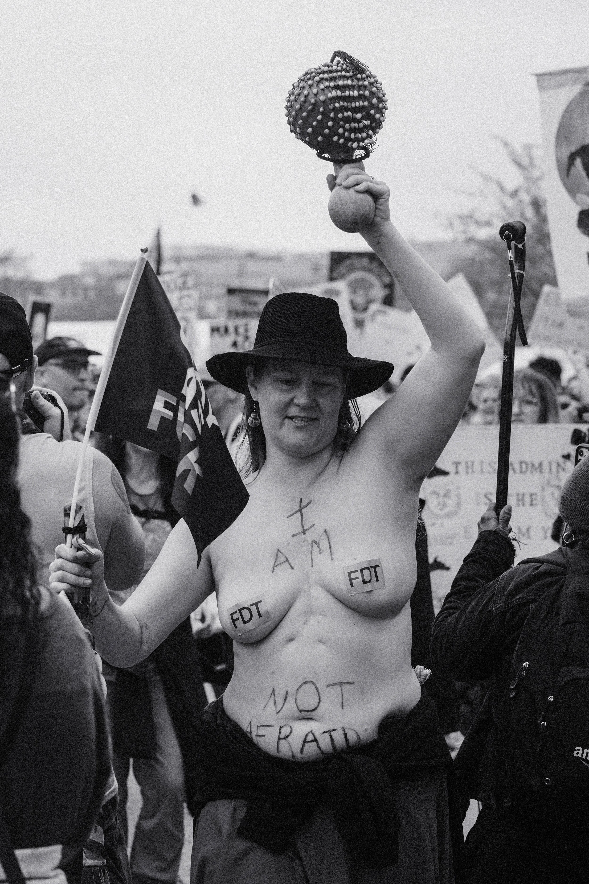 A woman protesting topless to show her lack of fear.