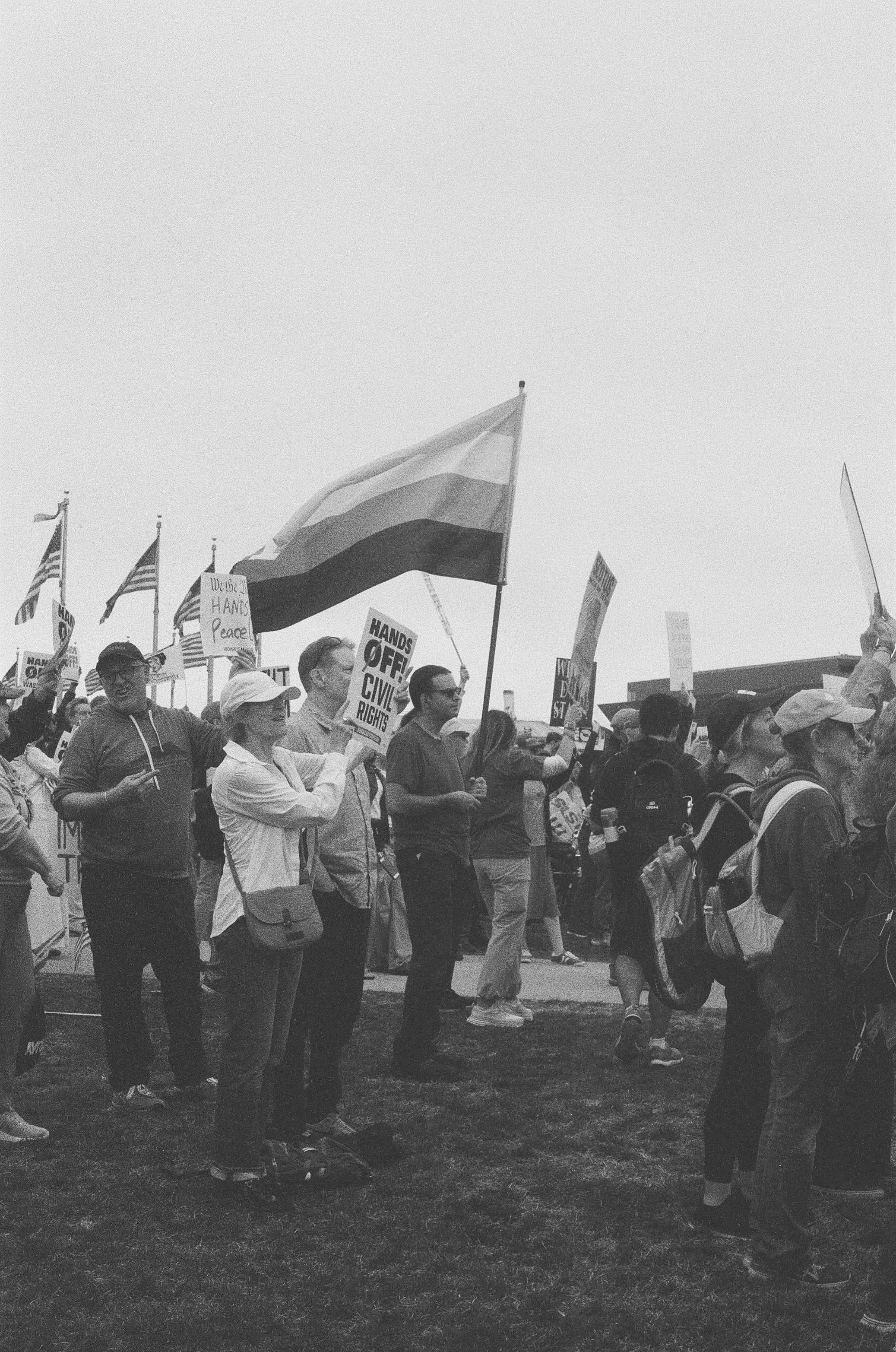 Protesters wield a transgender pride flag on the law of the Washington Monument.