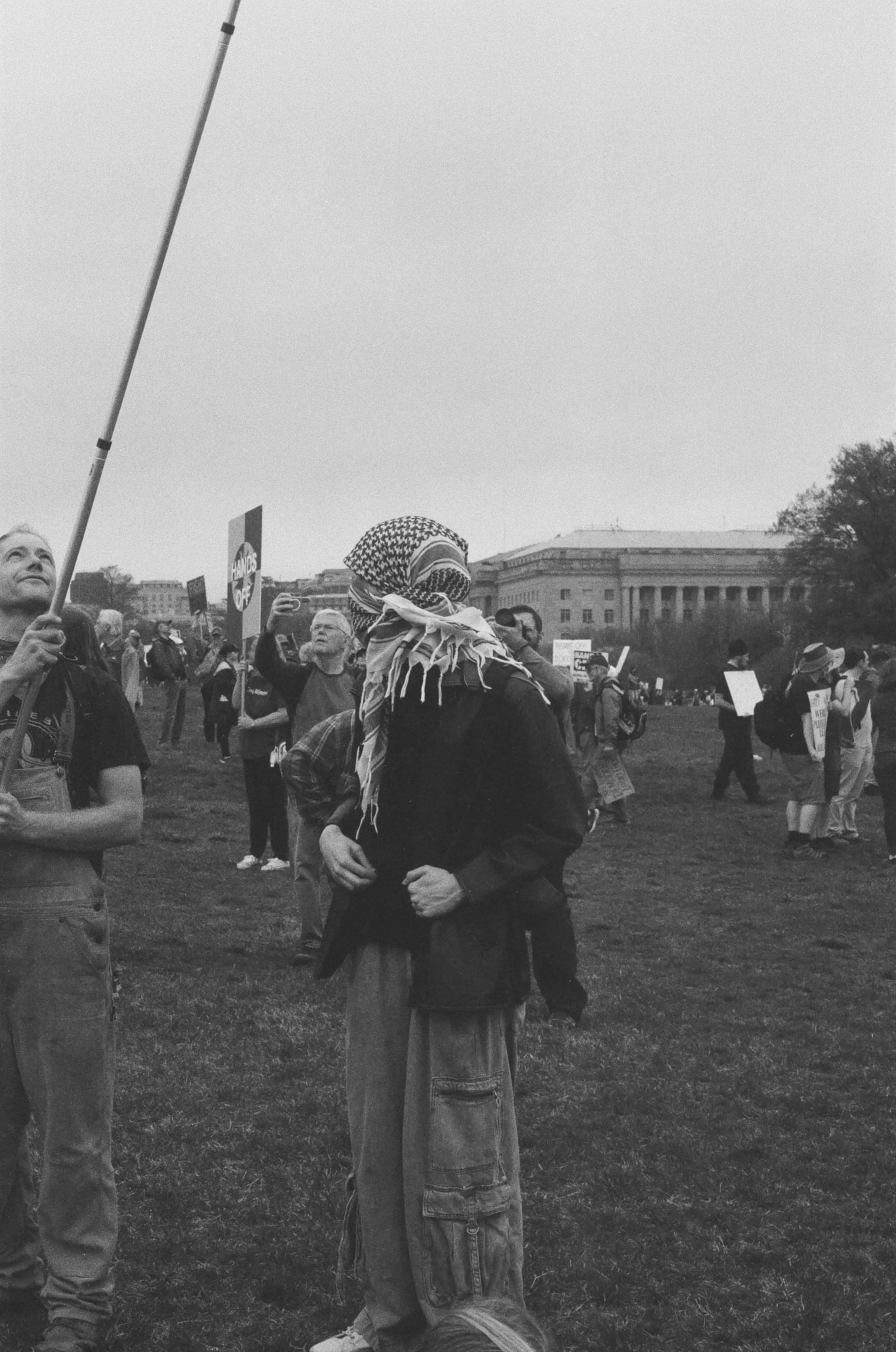 A protestor wears a full keffiyeh.