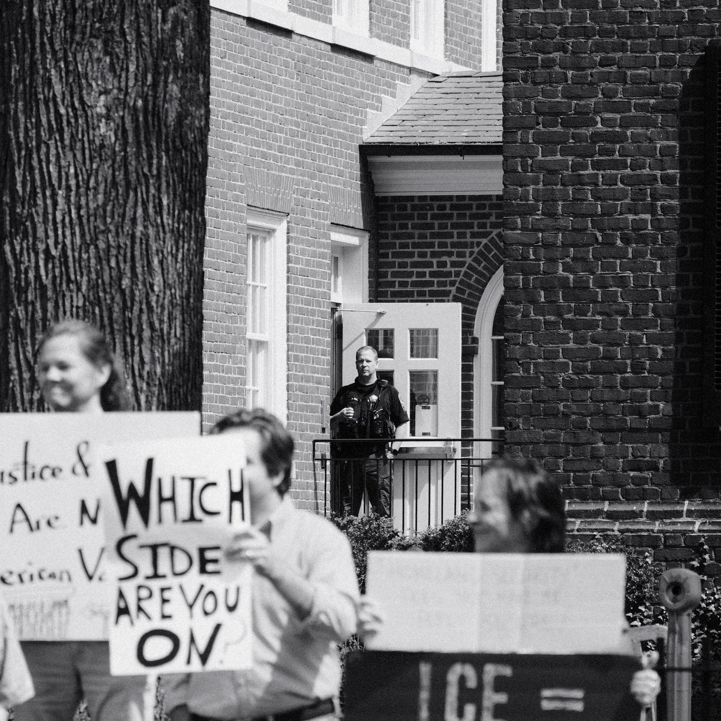 A law enforcement officer watching the protest outside the courthouse.