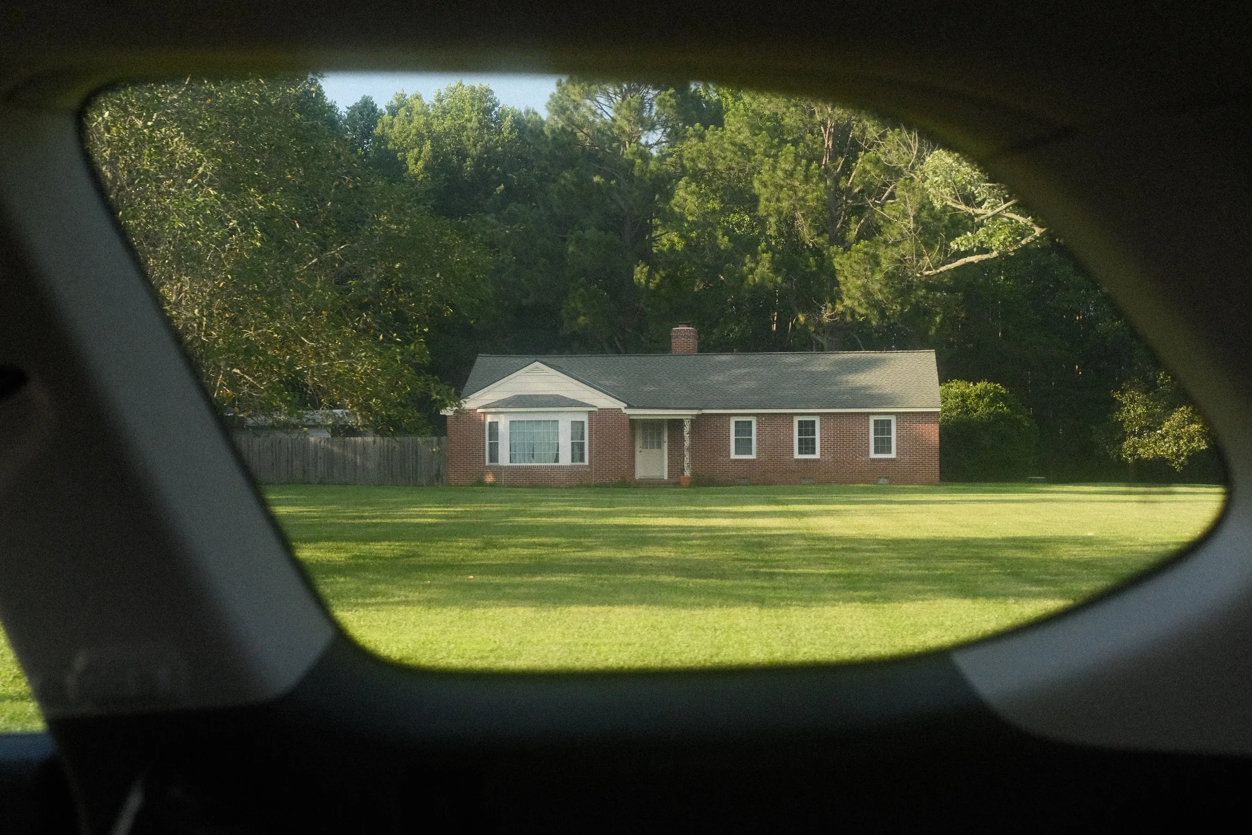 A house in the Tidewater through the frame of a car window.