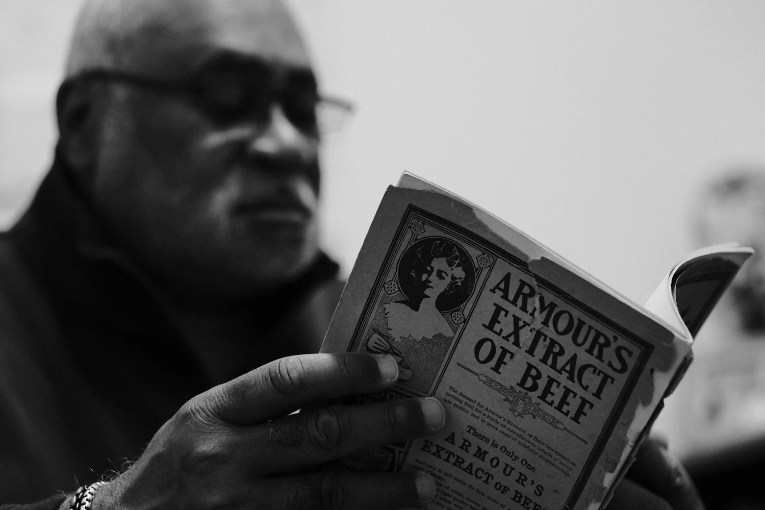 A teacher reading a extremely old book.