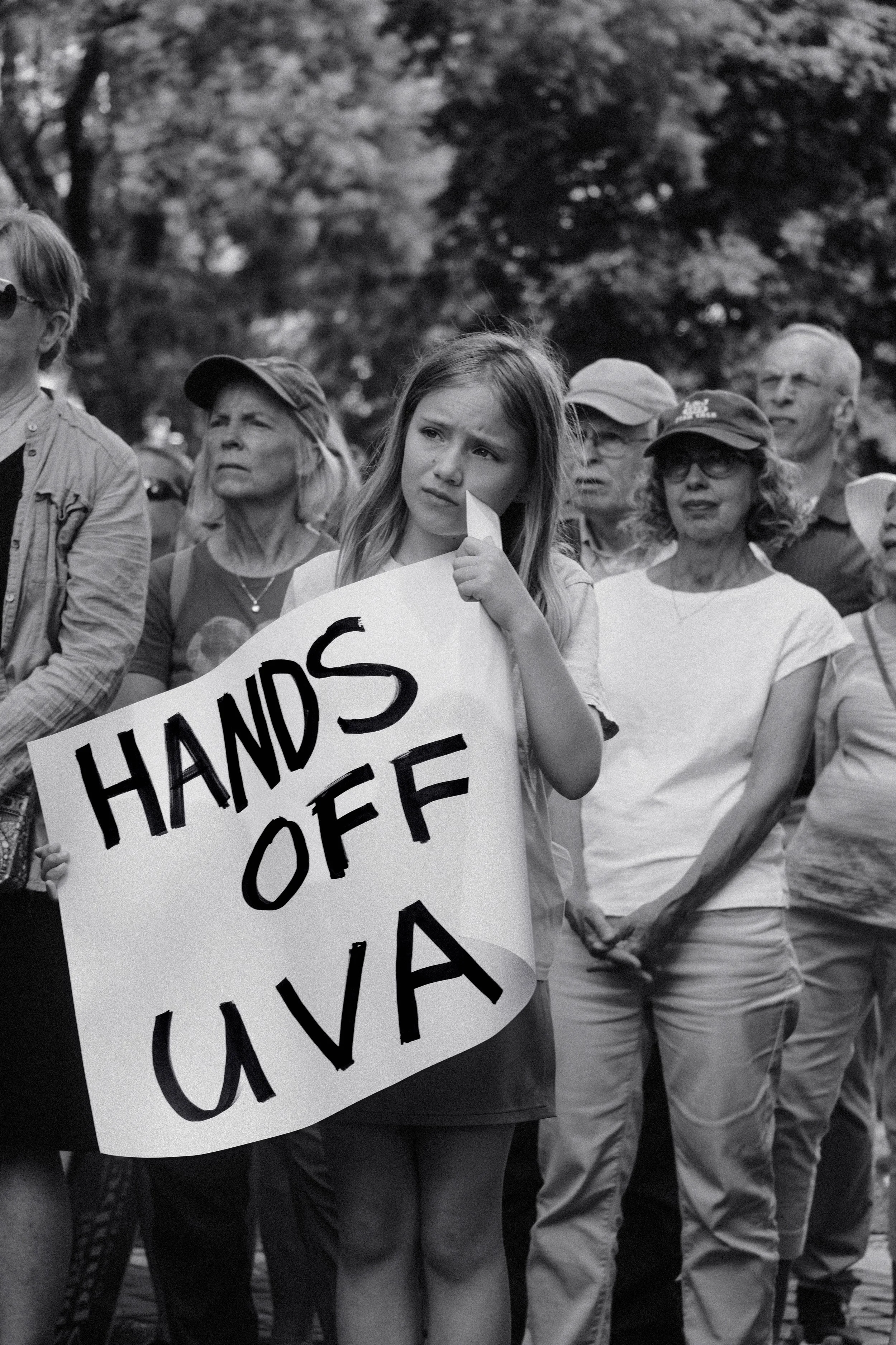 A young child seemingly on the verge of tears at a protest for UVA.