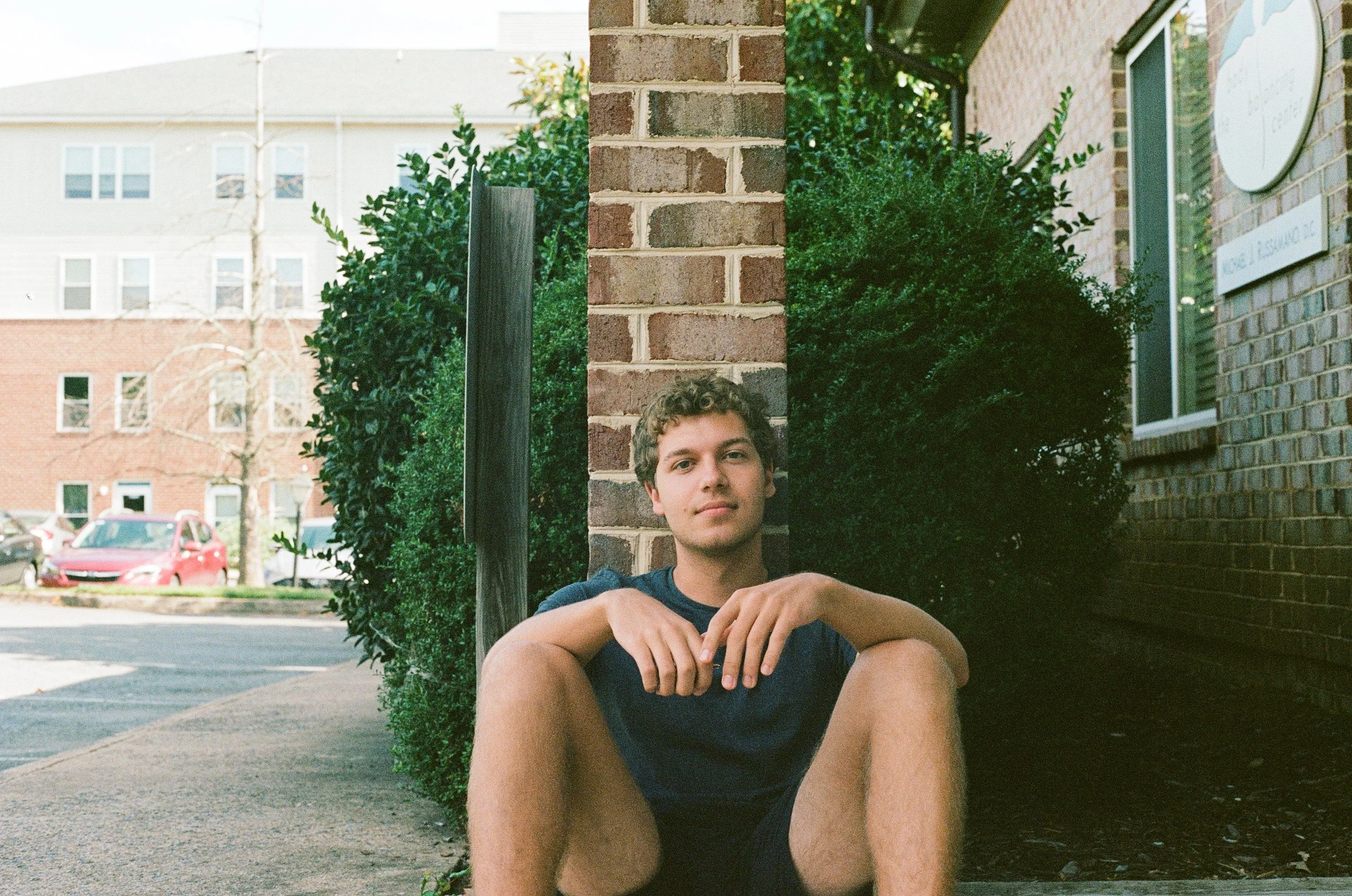 A Harris-Walz campaign staffer sits exhausted outside his office.