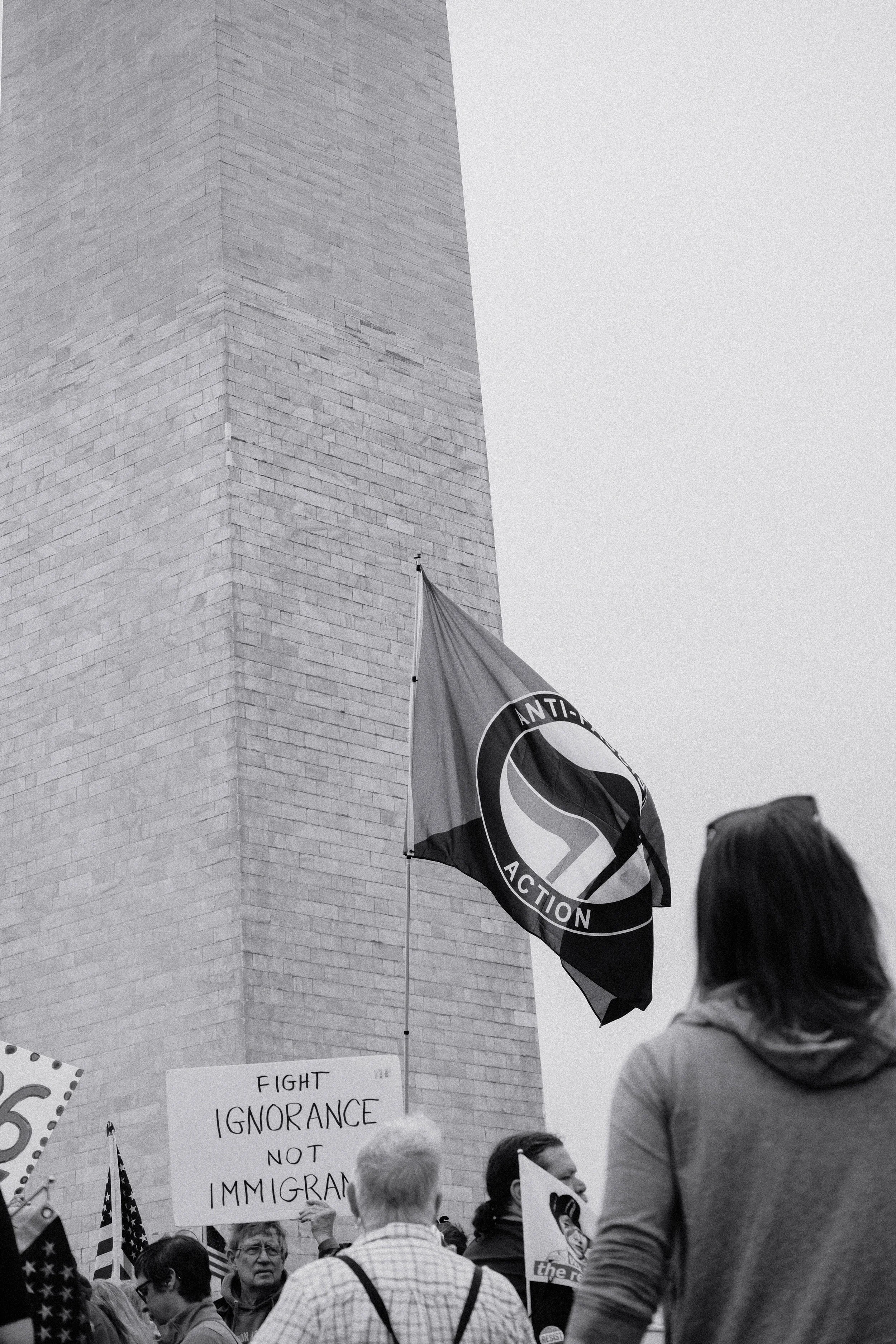 An antifa flag held by a protester flag against the backdrop of the Washington Monument.