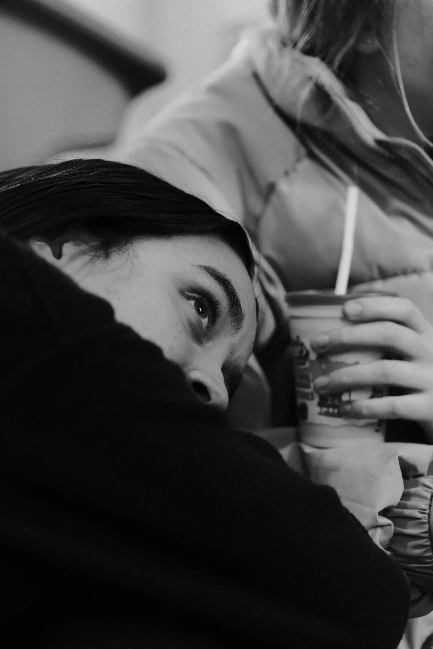 A friend lays on her friend's lap after a long lecture.