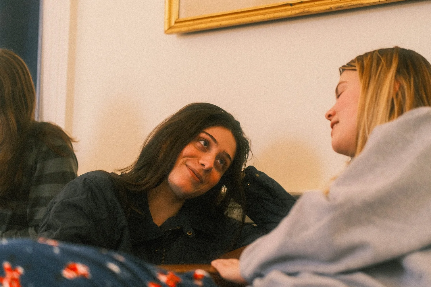 Two friends chat in a lounge.