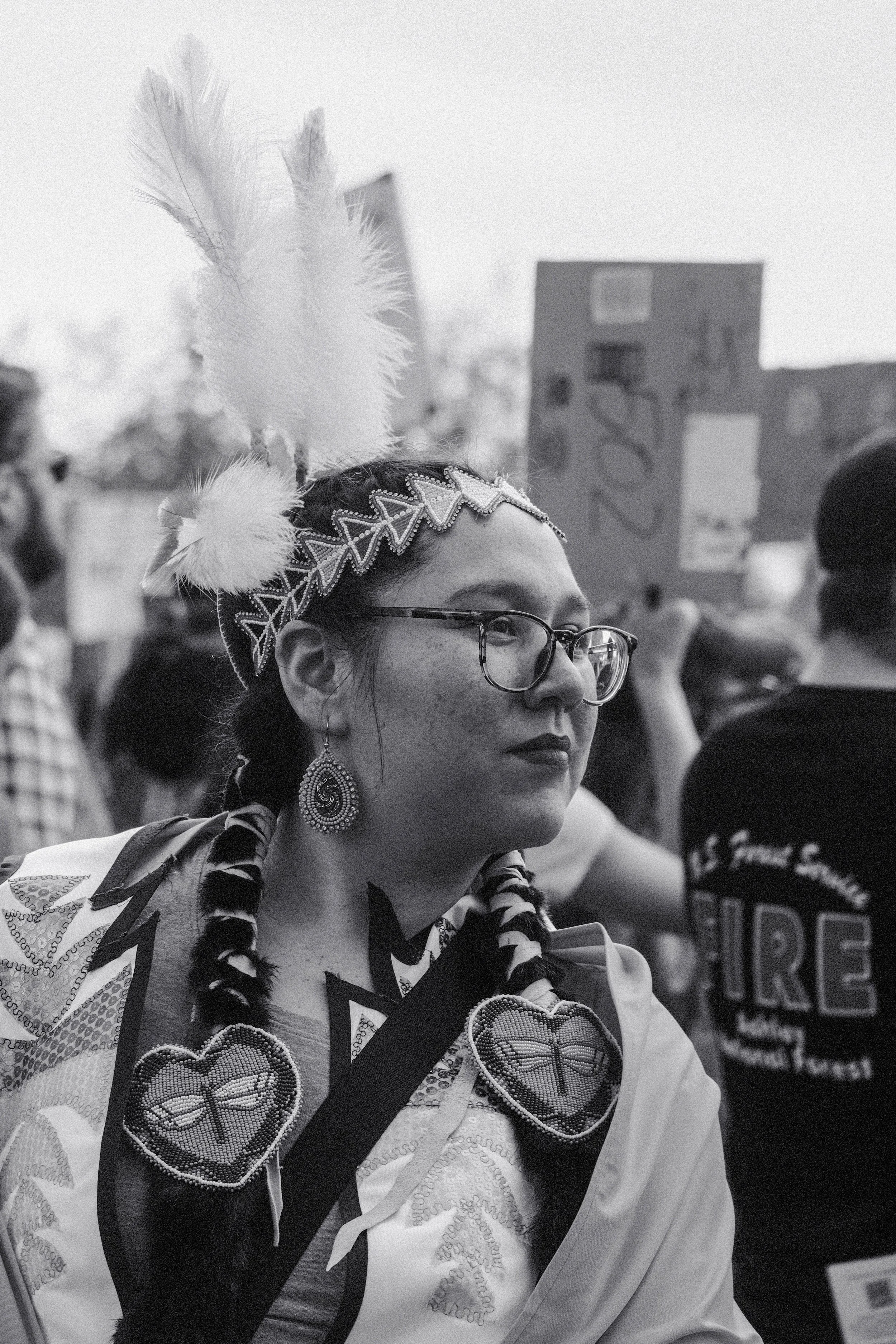 An indigenous woman in traditional clothing protesting.