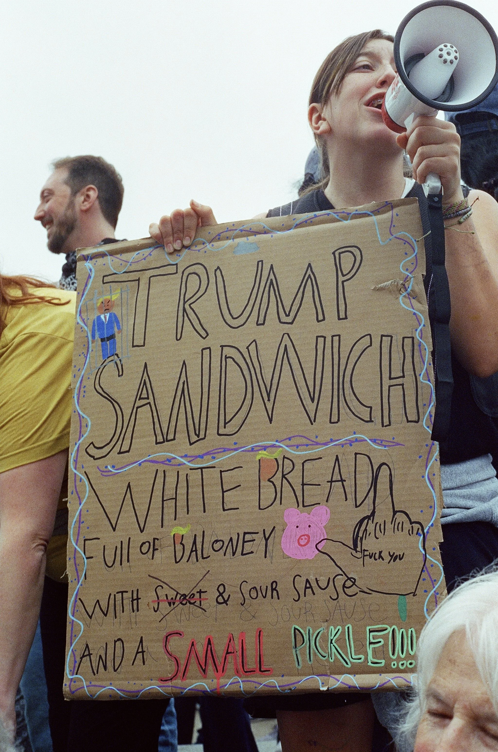 A protester with a megaphone and sign.