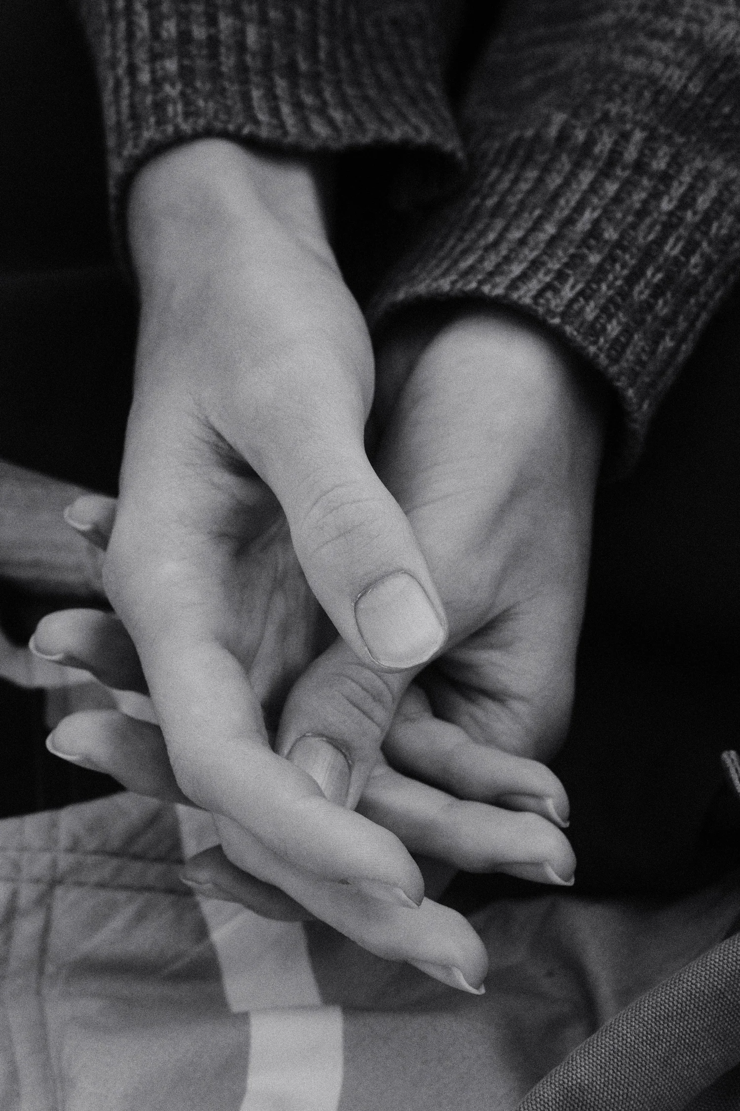 A student nervously holding his own hand.
