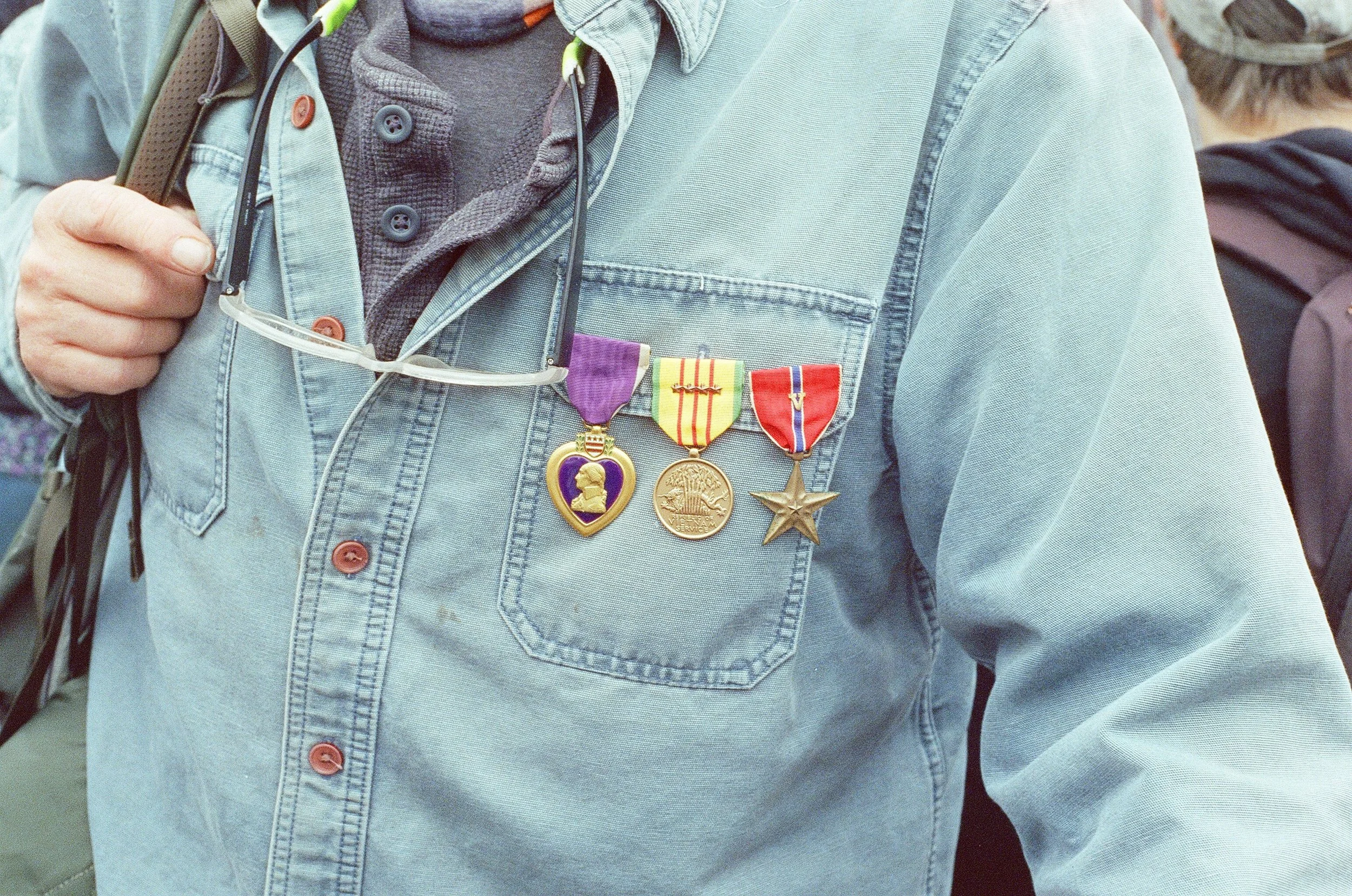 A man and his purple heart at a protest against Trump.