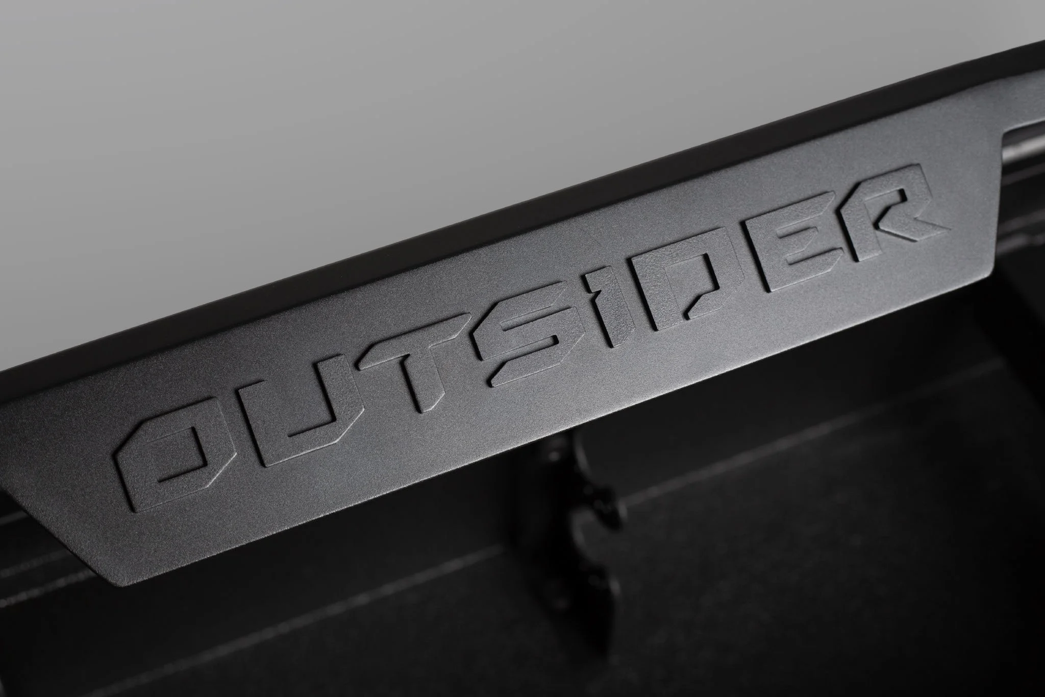 Close-up of a black gaming console with the word 'STEALTH' embossed on it.
