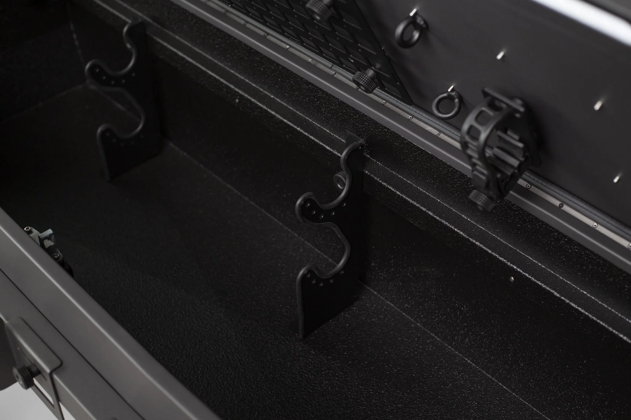 Close-up of the interior of a safe or lockbox showing the empty compartment and locking mechanism.