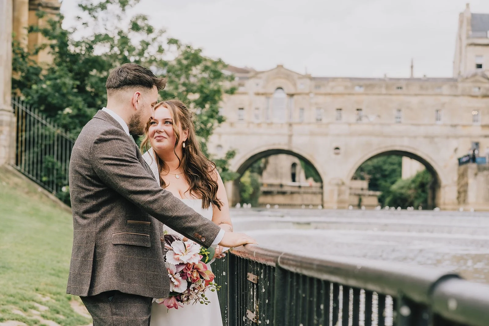 Bride and groom at Bath Weir with Pultney Bridge in background