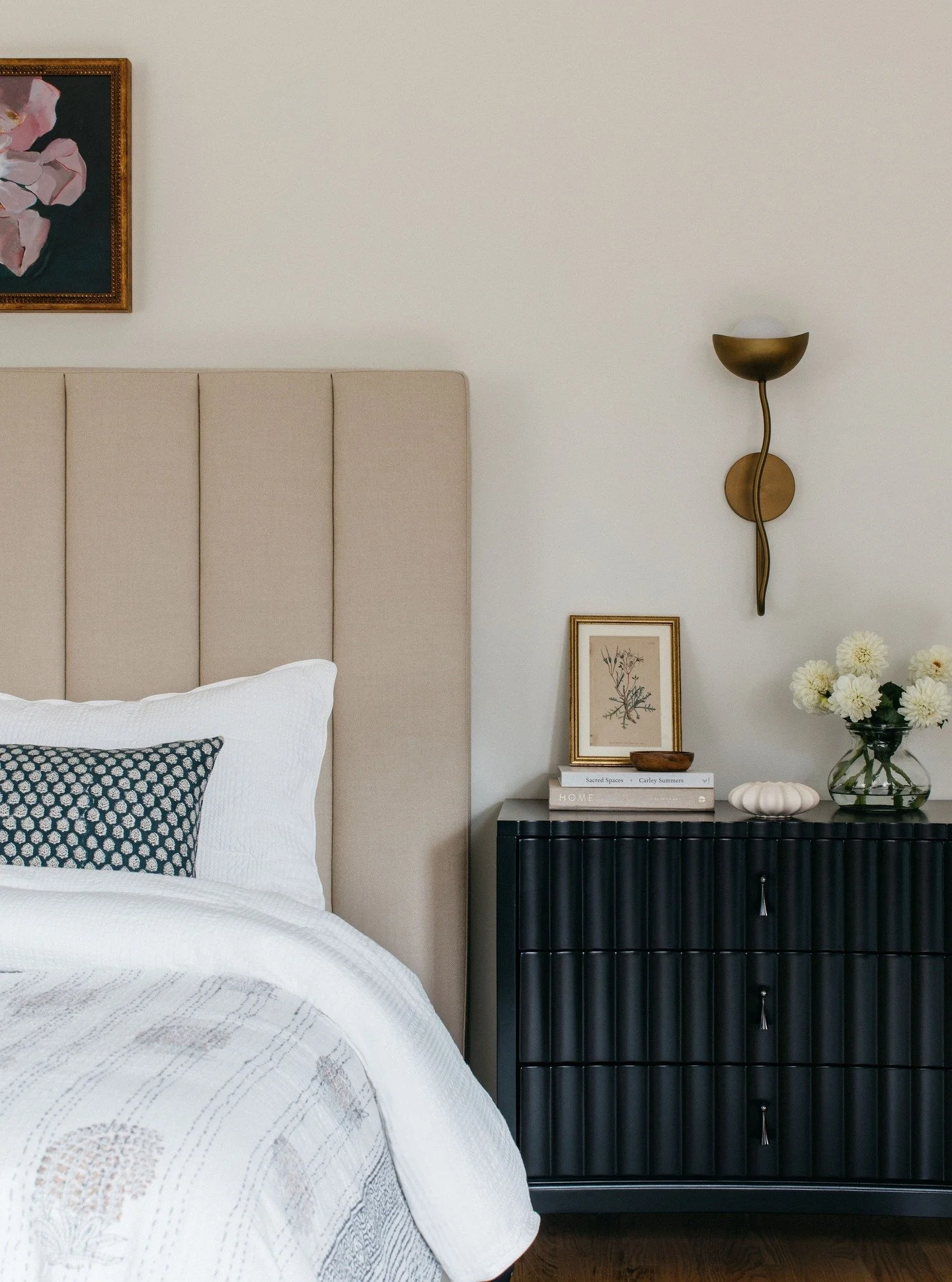Bedrooms seem simple, but getting them to feel calm and elevated takes a little time, patience and intentional layering.

The magic is all in the mix here. The tall, tailored headboard brings structure. The sculptural curves in the sconce breaks up t