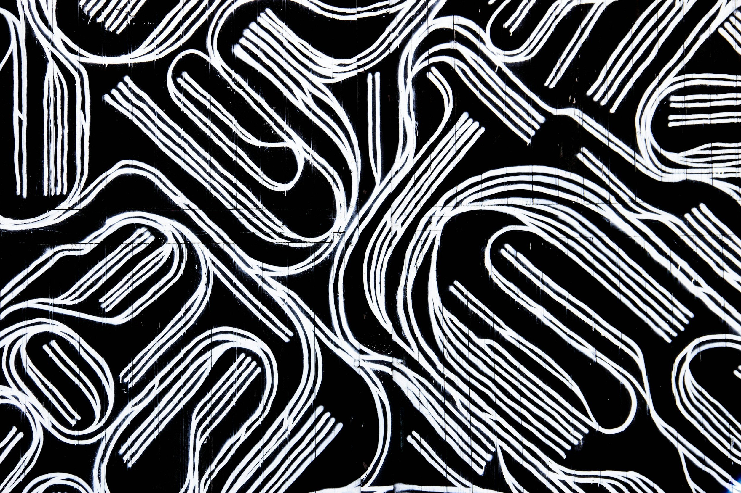 Black background with white abstract geometric line art.