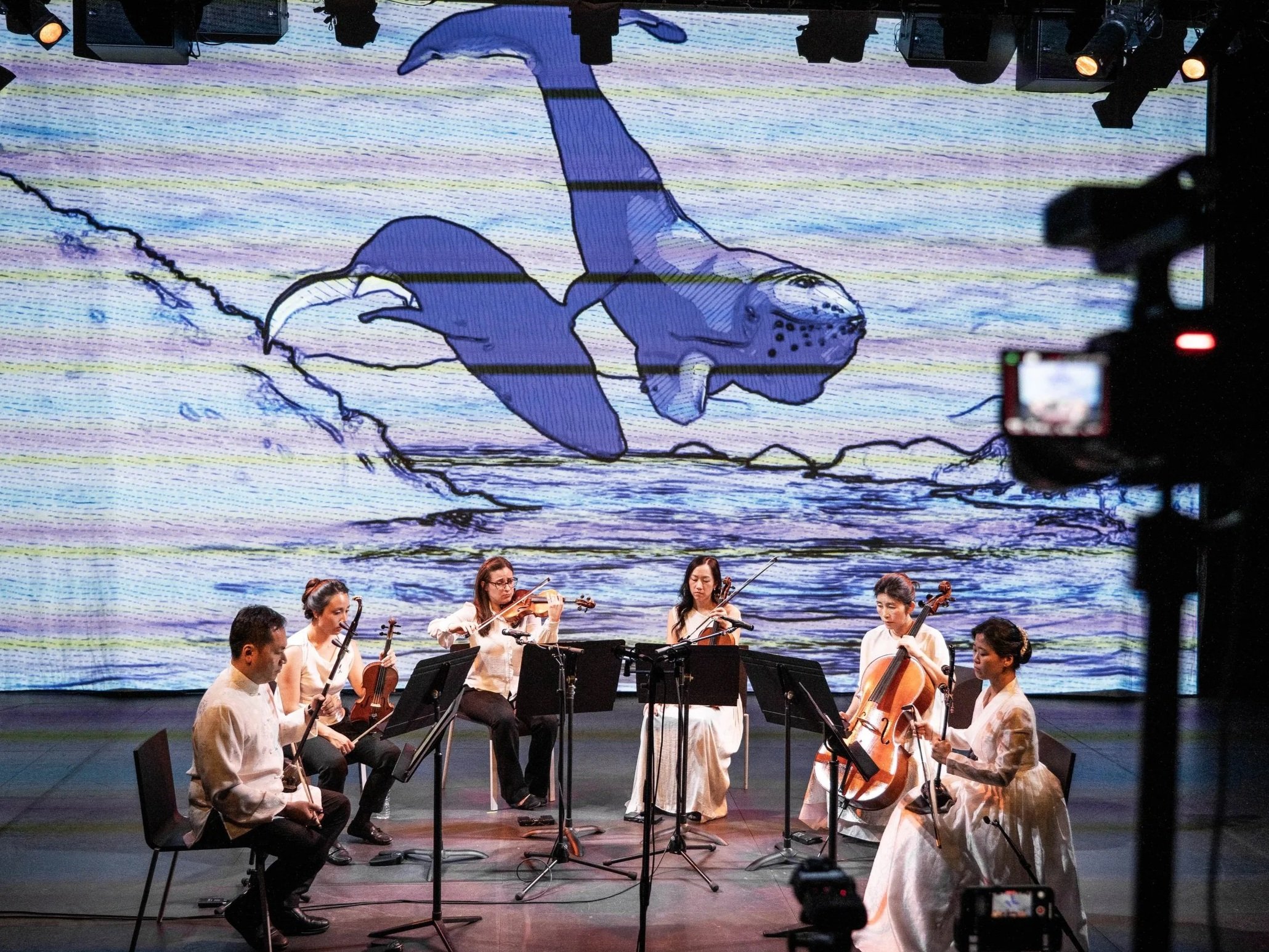 Photo of Calling of the Whales performance from Strings Attached Across the Pacific, composed and produced by Hee Yun Kim; Elevator Project at AT&T Performing Arts Center