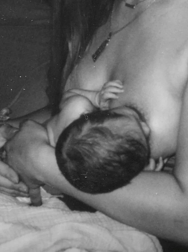 postpartum mother breastfeeding newborn in home in Richmond, Virginia