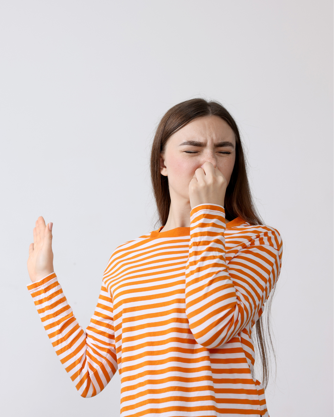 girl holding her nose, smelling stinky water
