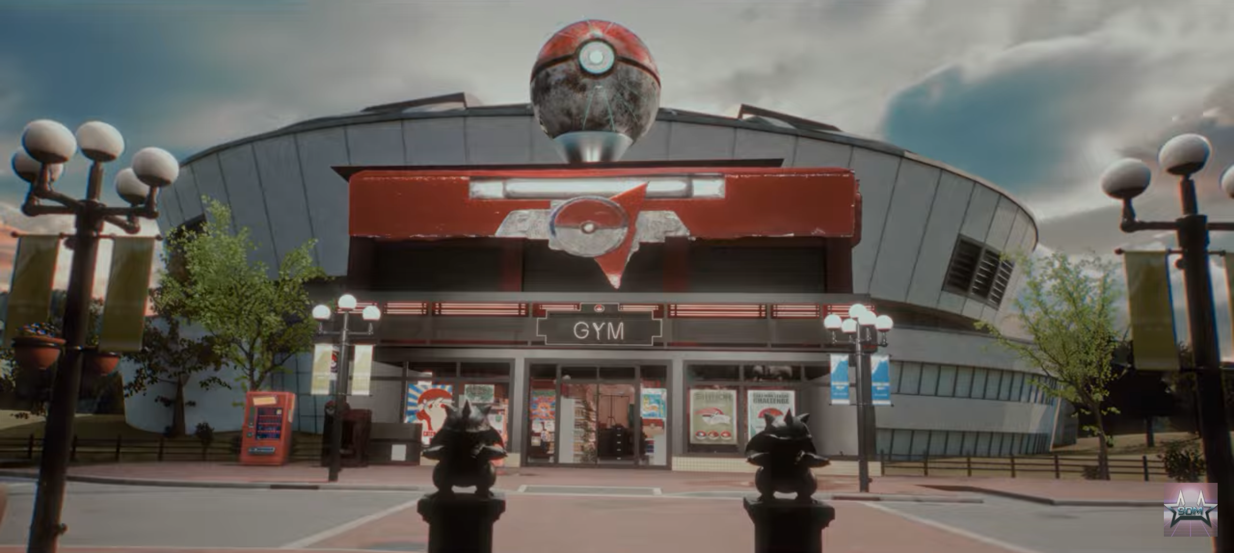 A modern gym building with Pokémon-themed decorations, including a Pokéball emblem on the facade and two Pokémon statues in the foreground.