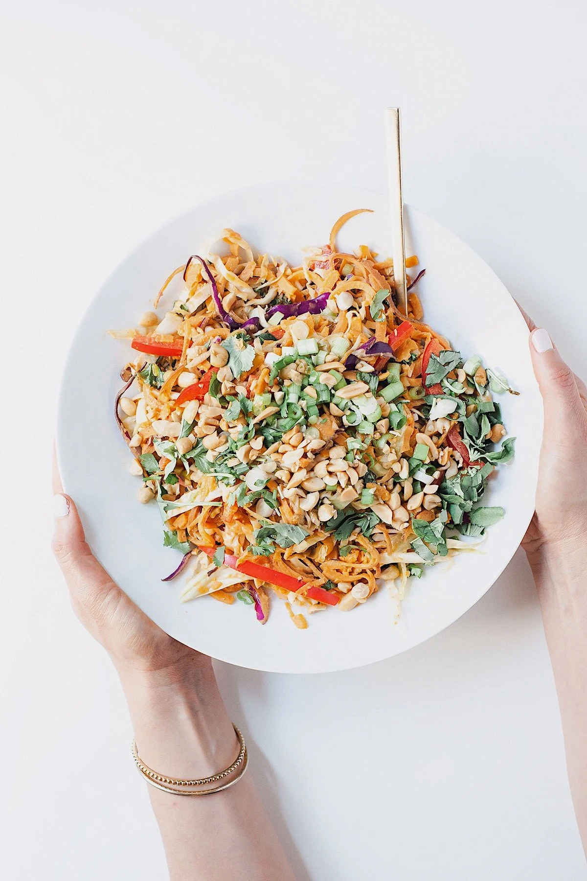 Sweet potato noodle bowl drizzled with coconut peanut sauce.