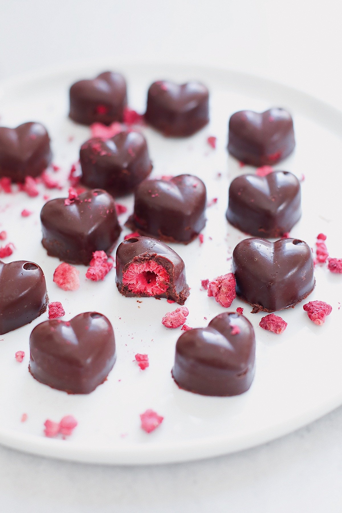 Close-up of homemade raspberry chocolate with raspberry center and dark chocolate coating.