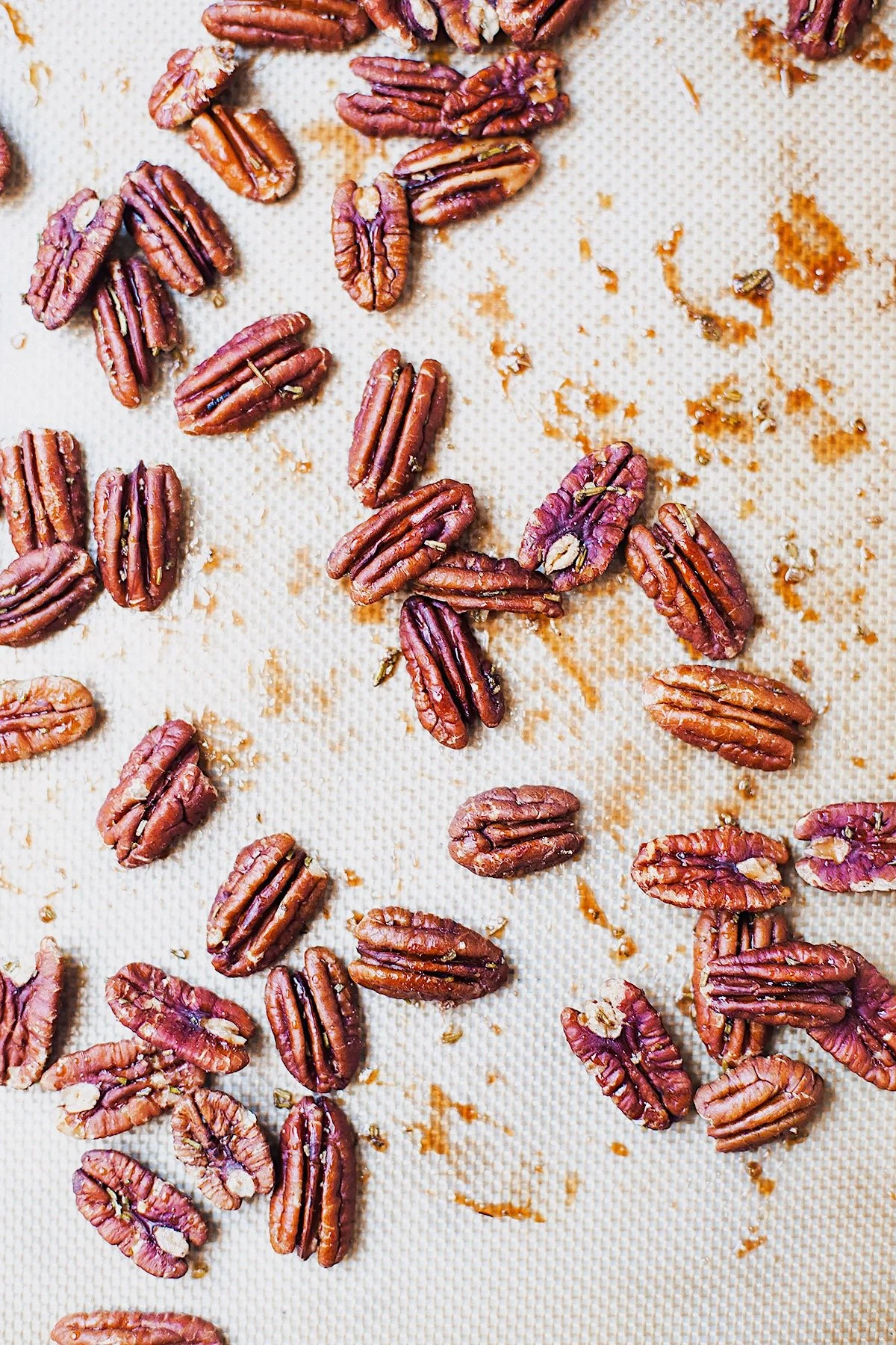 Maple-rosemary pecans roasted on a sheet pan.