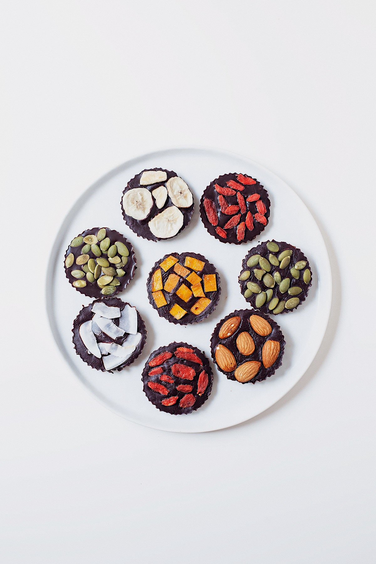Assorted homemade chocolate pieces with toppings.