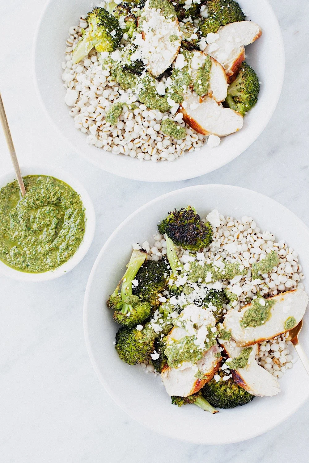 Broccoli pesto bowls with Job’s tears, roasted broccoli, chicken, feta, and green pesto.