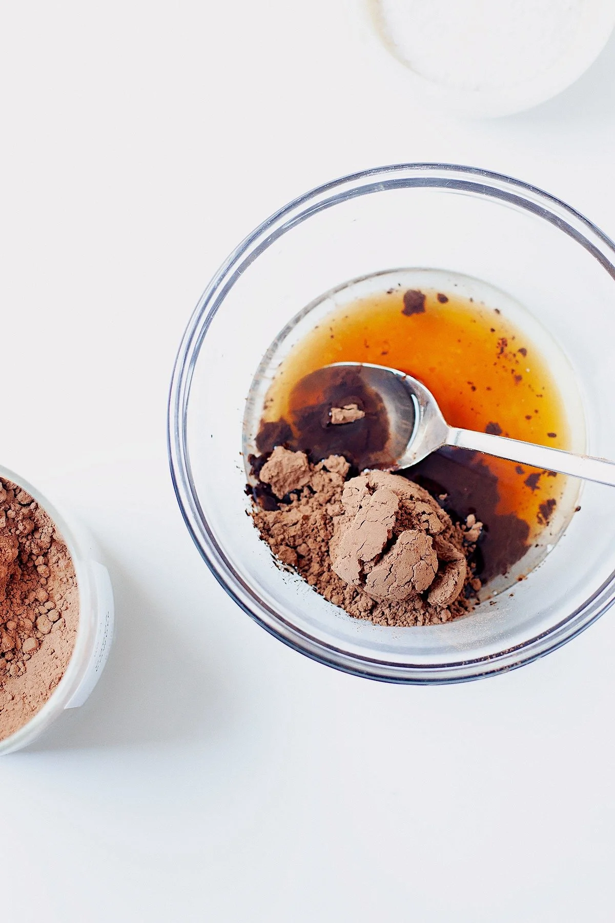 Melting chocolate mixture in a glass bowl with coconut oil and cacao.