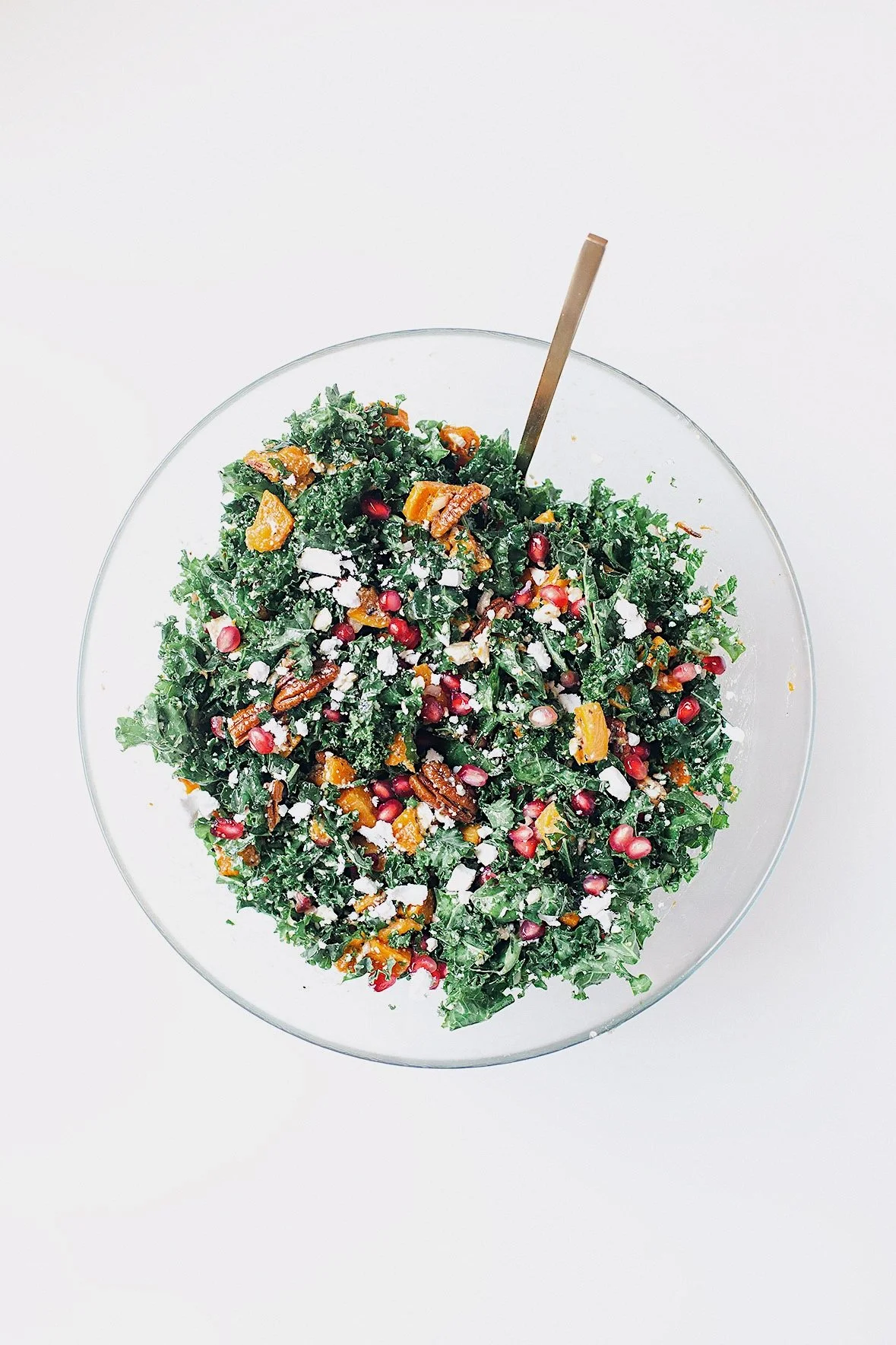 Overhead shot of Thanksgiving kale salad with butternut squash, pomegranate, and pecans.