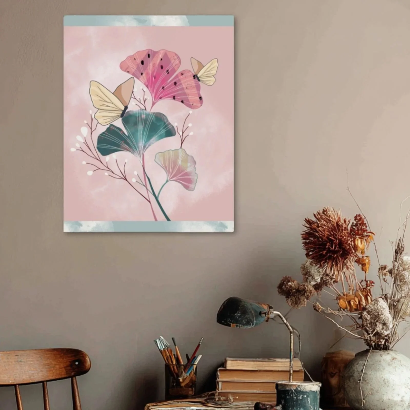 Blush-toned botanical art print displayed in a cozy setting with books, dried florals, and warm lighting.