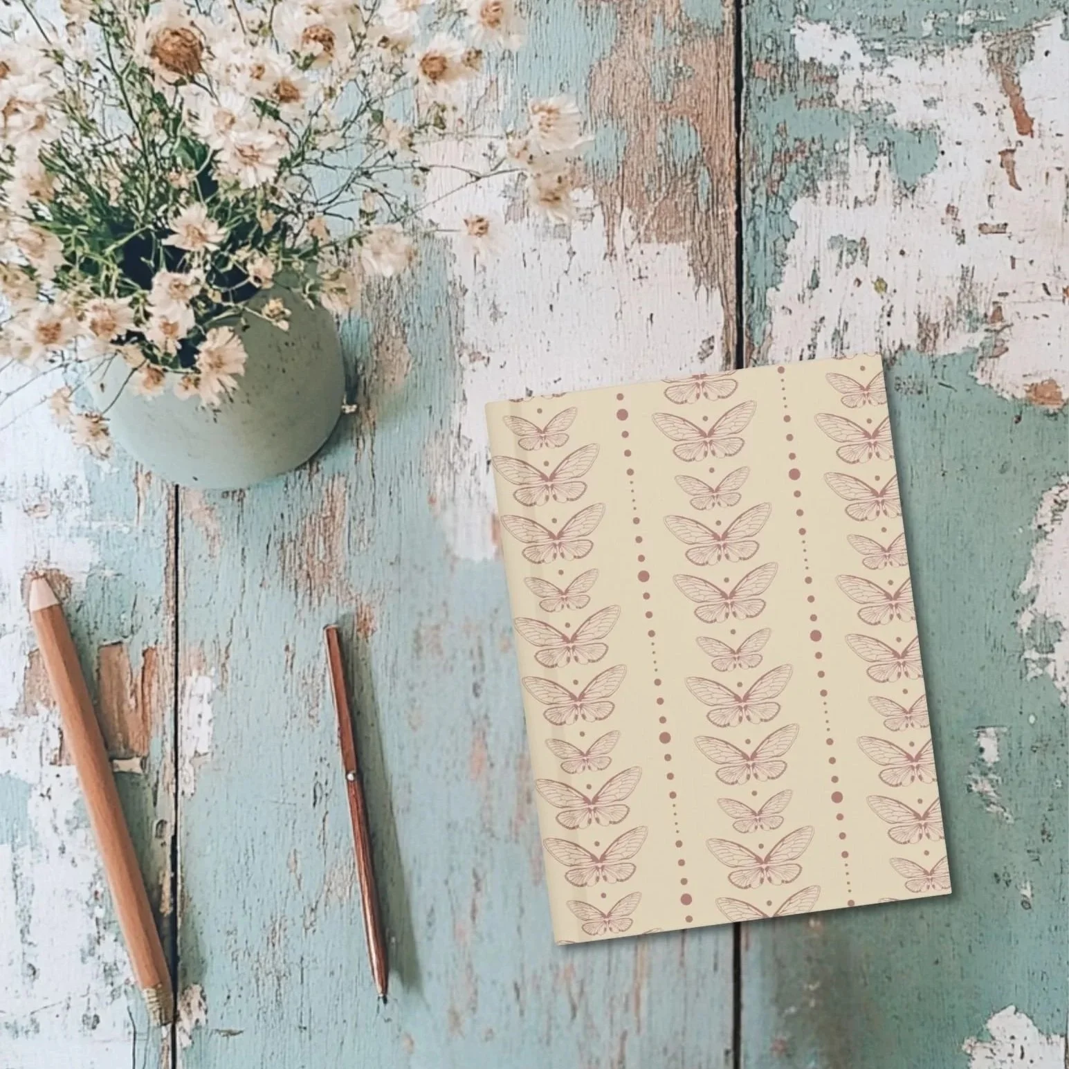 Still Wing Archive journal on rustic table with dried flowers and pencils – moth pattern cover