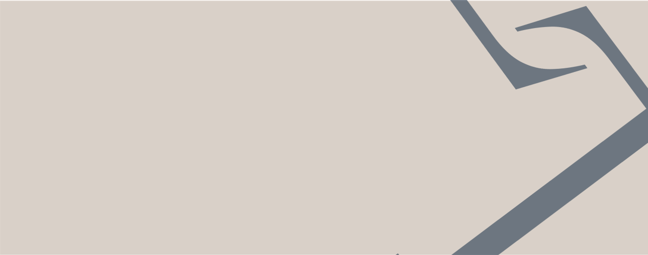 Close-up of a beige-colored document or table with a dark paperclip attached to the top right corner.