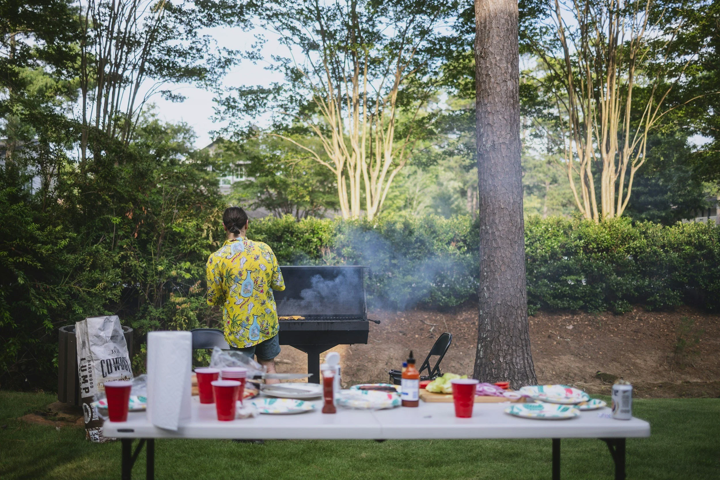 Family preparing for a summer backyard cookout in a clean Atlanta home with an outdoor grilling area and guest-ready patio.