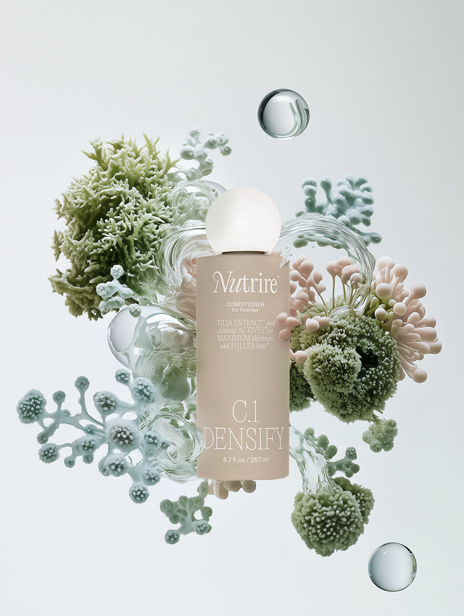 Bottle of Nutrire C.1 Densify conditioner surrounded by green coral-like plants and bubbles.