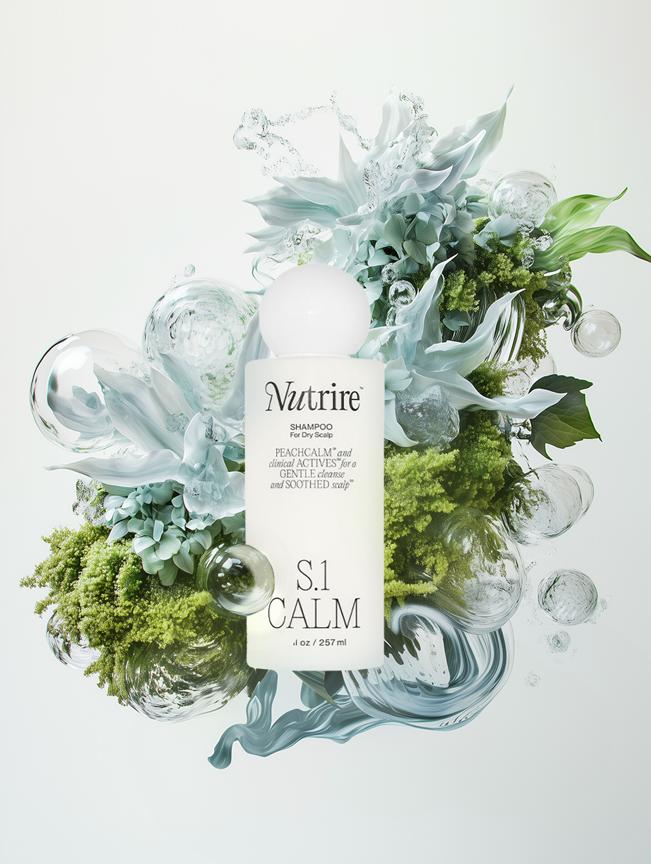Bottle of Nutire S.1 Calm shampoo surrounded by abstract floral and water-like elements with green foliage.