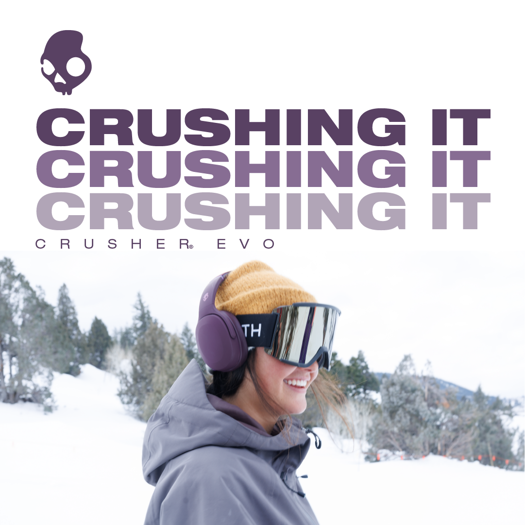 Young woman in ski gear, wearing goggles and headphones, enjoying a snowy mountain landscape.