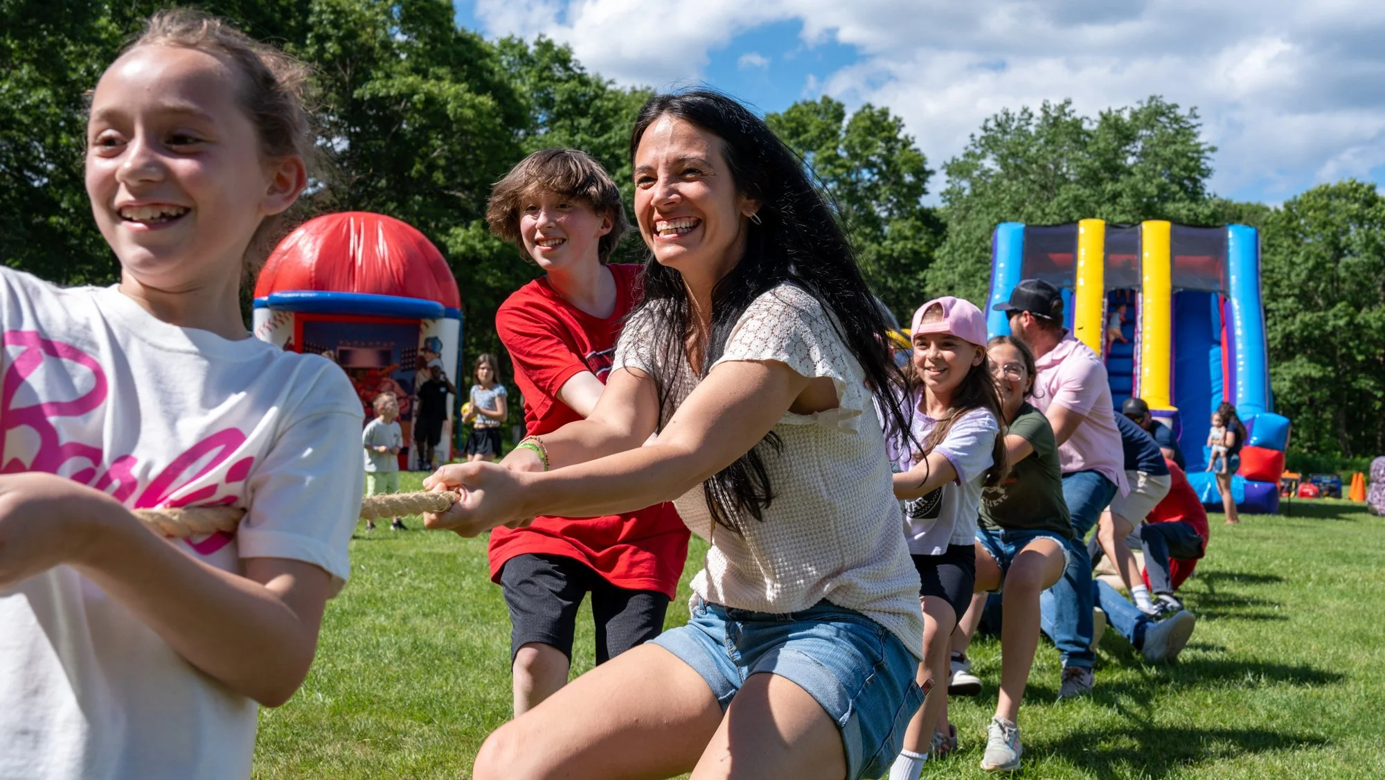 Fitness equipment in a room with a black-and-white photo of a woman in denim shorts and tank top holding a surfboard on the wall.