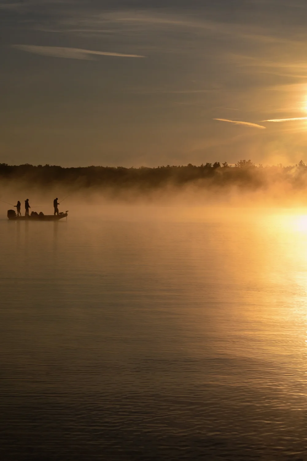 Morning Mist on Lake Joseph by MrSpacetime: a small boat in golden mist at sunrise