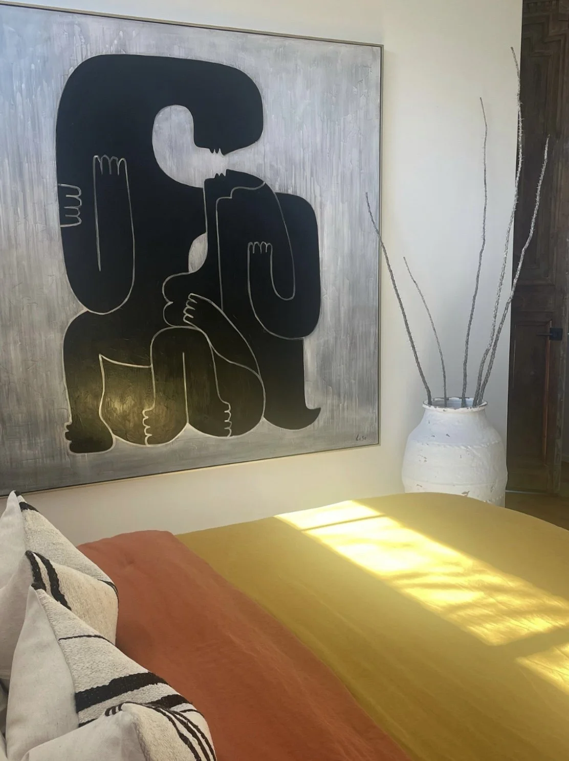 Modern bedroom designed by Austin interior designer HOLLEYHOUSE with decorative pillows and vase