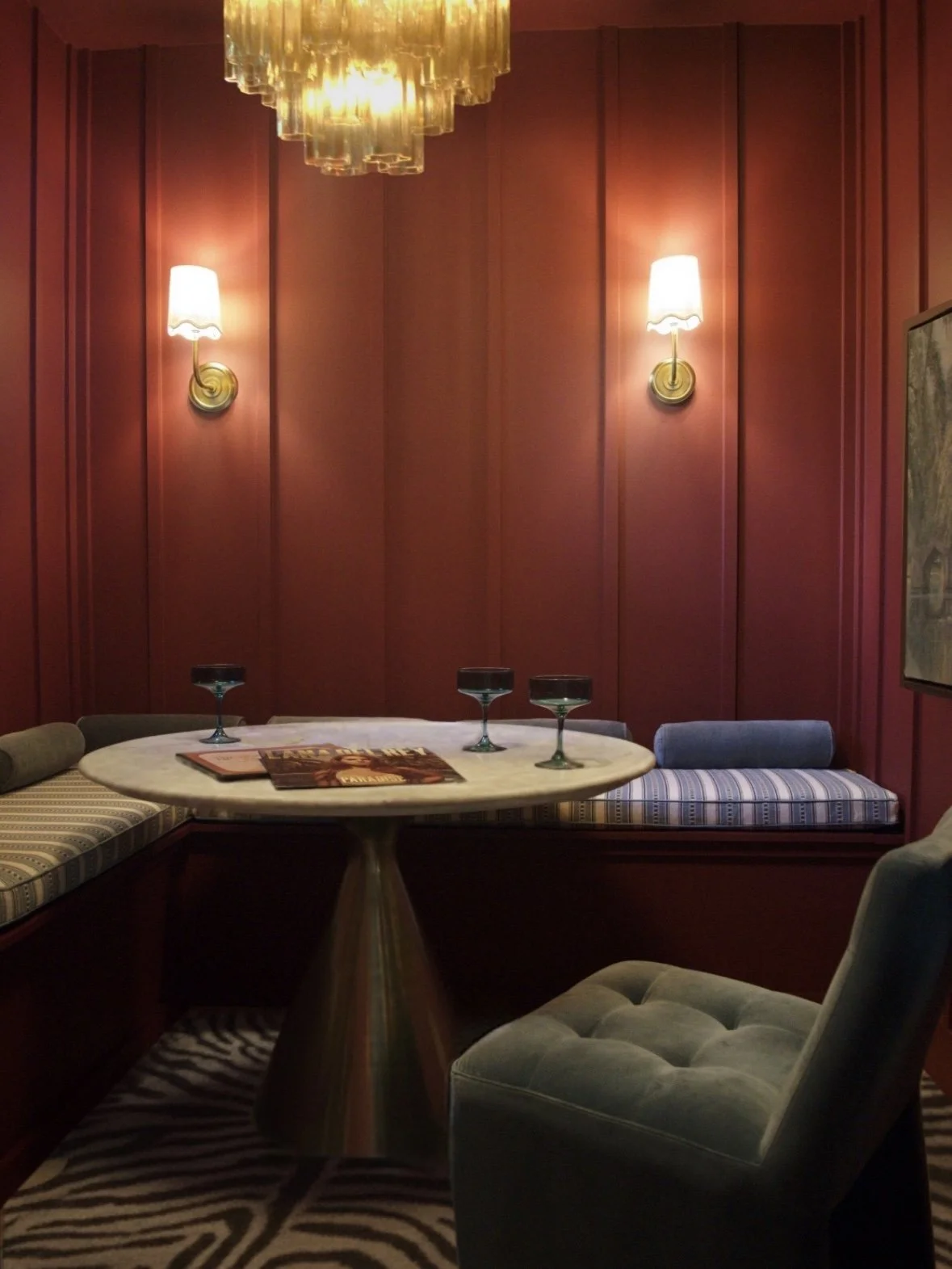 Bold dining room designed by Austin interior designer HOLLEYHOUSE with textured rug and sconces