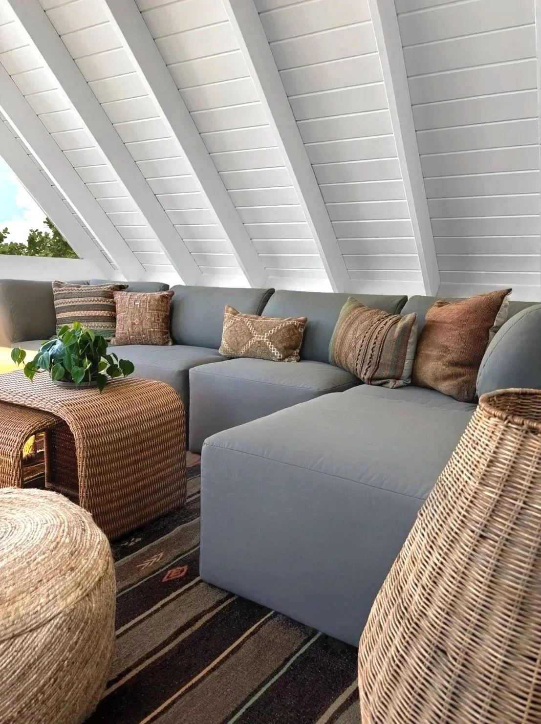 Sleek lounge area designed by Austin interior designer HOLLEYHOUSE with couch and throw pillows