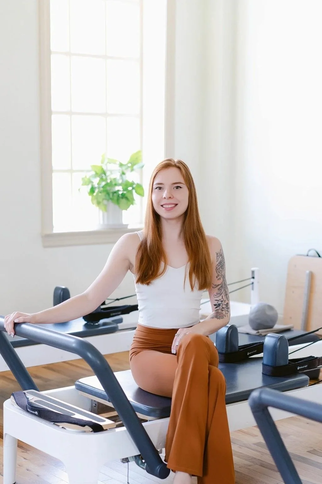Founder of Bloom Analytics on a Pilates reformer, empowering studio owners with clarity, confidence, and strategy for sustainable studio growth