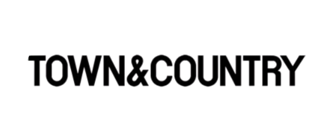 Silhouette of mountains and a tree with a sunset in the background, overlaid with the text 'TOWN & COUNTRY' in bold capital letters.