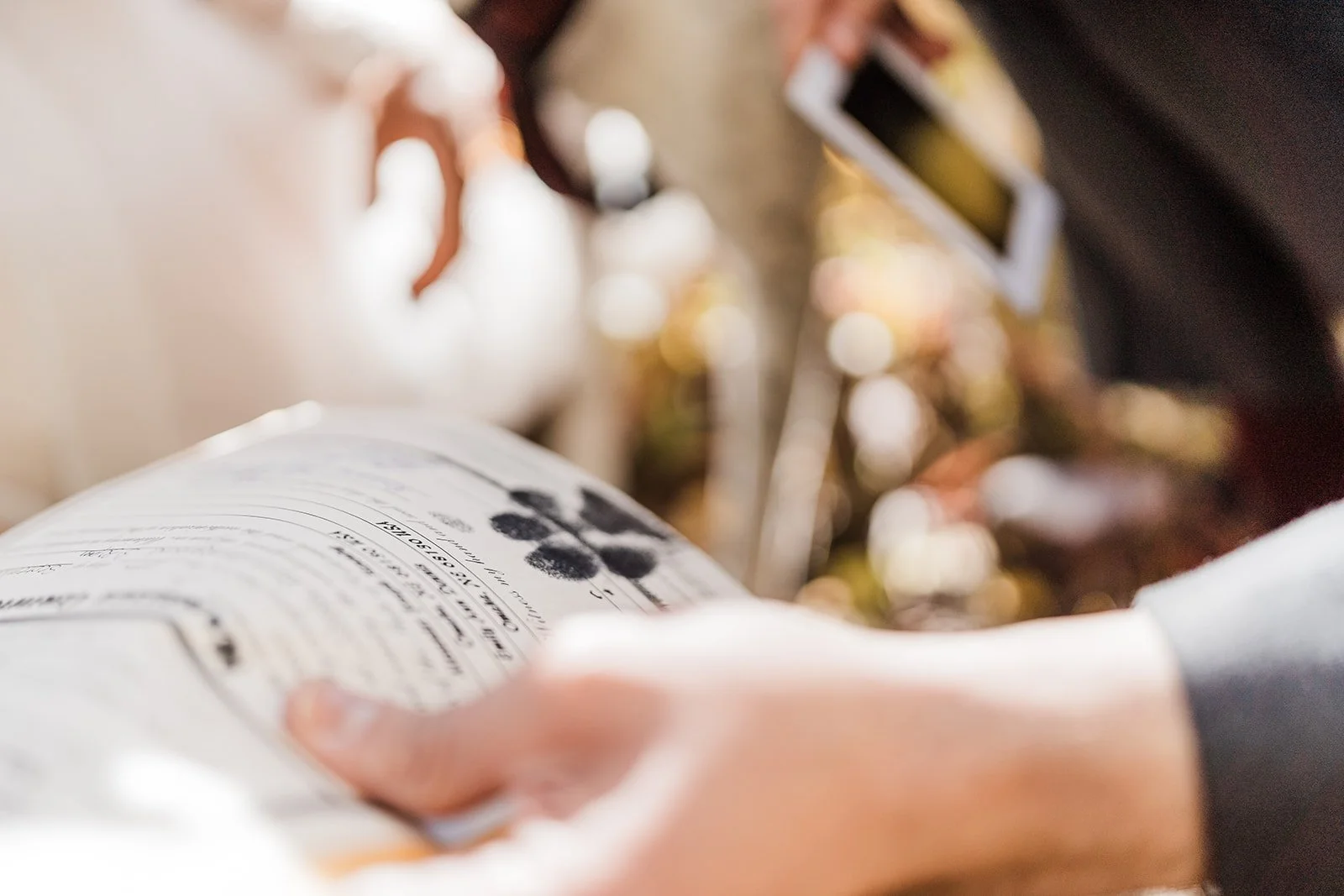 A person holding a bag of blackberries at a grocery store, with a checkout scanner visible in the background.